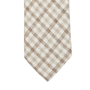 A close-up of a Brown Checked Wool Silk Lined Tie with a brown and white checkered pattern, by Amanda Christensen.