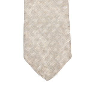 An Amanda Christensen Light Beige Herringbone Linen Lined Tie on a white background.