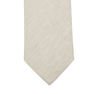 An Amanda Christensen Light Beige Herringbone Wool Silk Lined Tie on a white background.