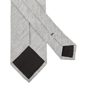 A Light Grey Herringbone Wool Silk Lined Tie from Amanda Christensen on a white background.