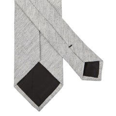 A Light Grey Herringbone Wool Silk Lined Tie from Amanda Christensen on a white background.