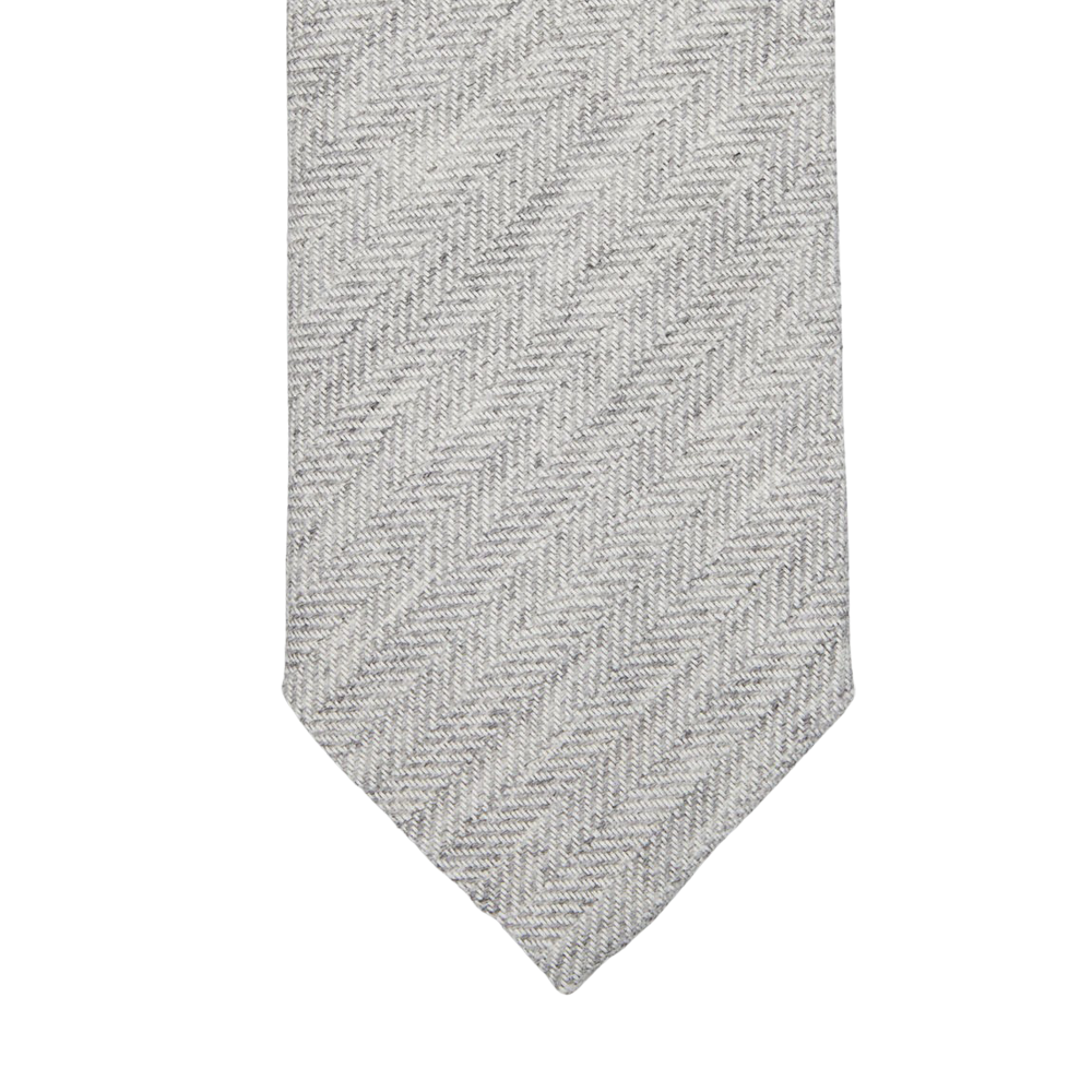 A Light Grey Herringbone Wool Silk Lined Tie by Amanda Christensen on a white background.
