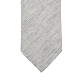A Light Grey Herringbone Wool Silk Lined Tie by Amanda Christensen on a white background.