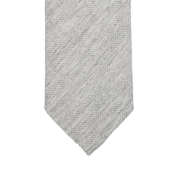 A Light Grey Herringbone Wool Silk Lined Tie by Amanda Christensen on a white background.