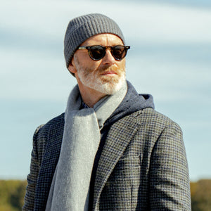 A man wearing a Amanda Christensen Mid Grey Cashmere Beanie and a scarf.
