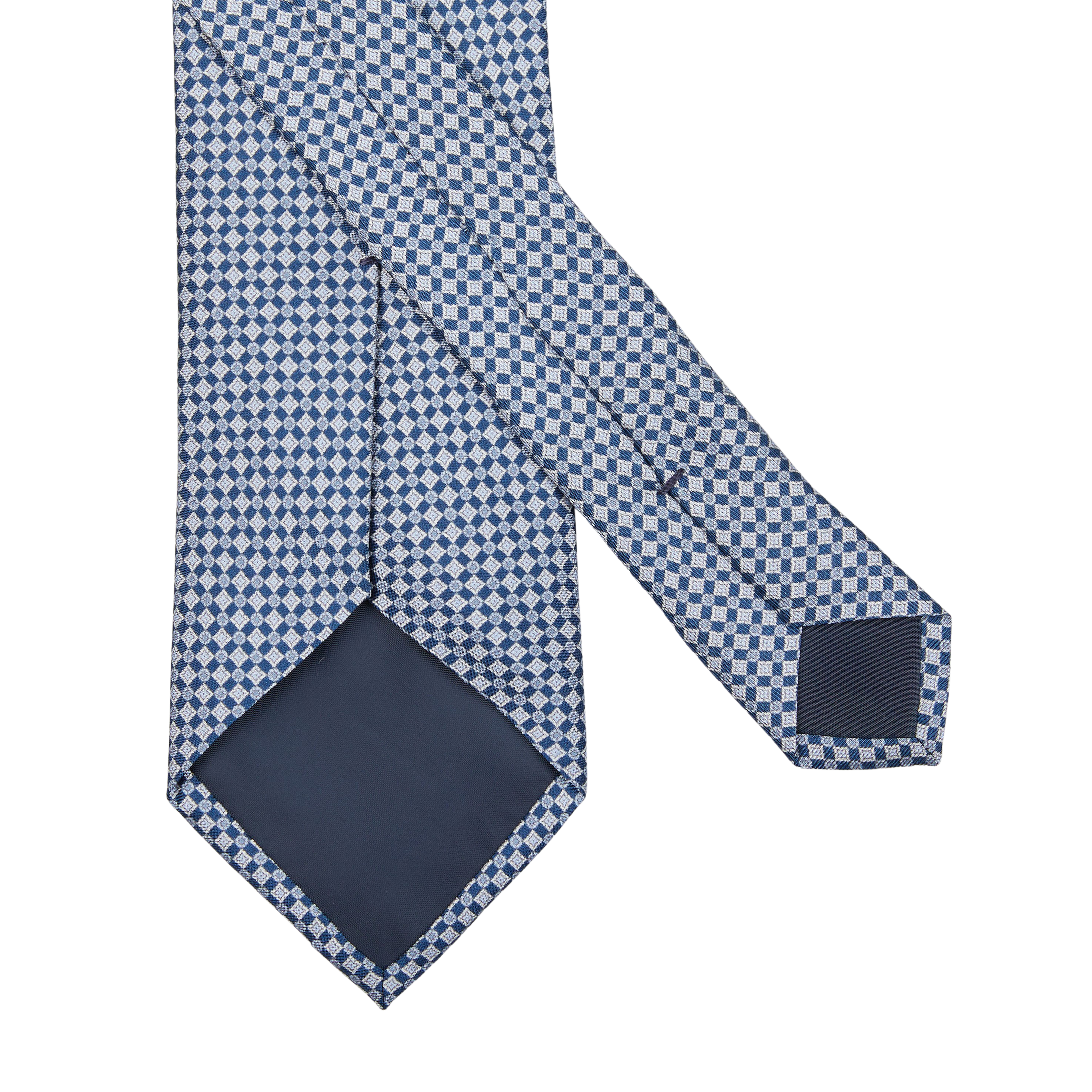 A navy blue micro medallion printed silk lined tie on a white background by Amanda Christensen.