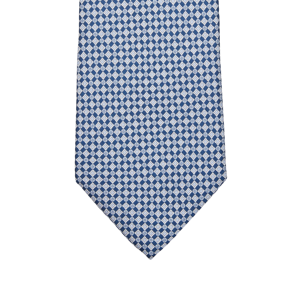 A navy blue micro medallion printed silk lined tie by Amanda Christensen on a white background.