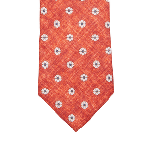 A Amanda Christensen red tie with an Orange Flower Printed Linen Lined on it.