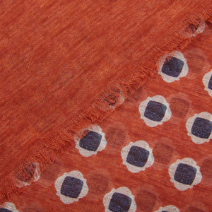Close-up of an Amanda Christensen Orange Geometrical Printed Cotton Scarf with frayed edges and a pattern of white and blue circles.