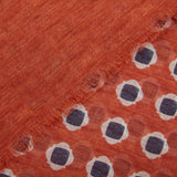 Close-up of an Amanda Christensen Orange Geometrical Printed Cotton Scarf with frayed edges and a pattern of white and blue circles.