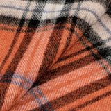 Close-up of an Amanda Christensen Orange Checked Virgin Wool Scarf featuring a plaid pattern in orange, black, white, and blue.