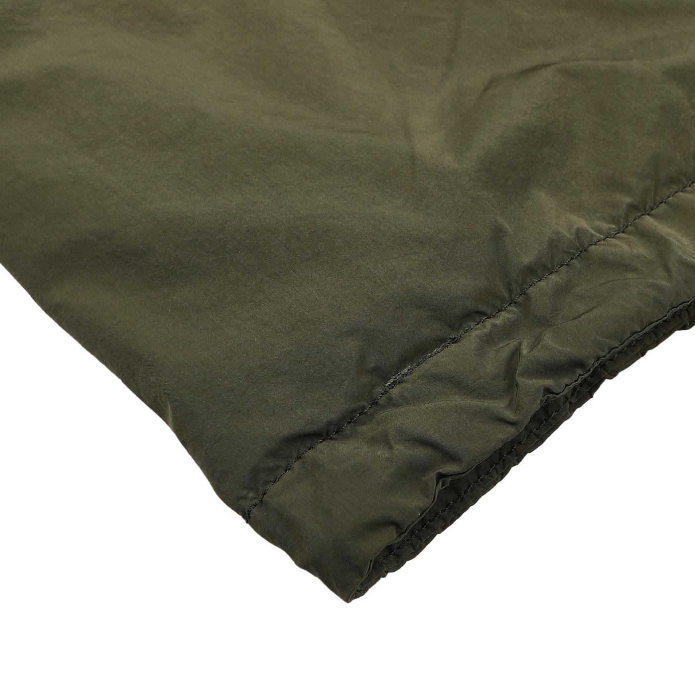 Close-up of a sleeve from an Aspesi Army Green Luxury Nylon Field Jacket, featuring an elastic cuff, made from durable nylon taffeta, lying on a white surface.