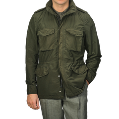 A man wearing an Aspesi Army Green Luxury Nylon Field Jacket with a classic military M65 style, paired with gray trousers.