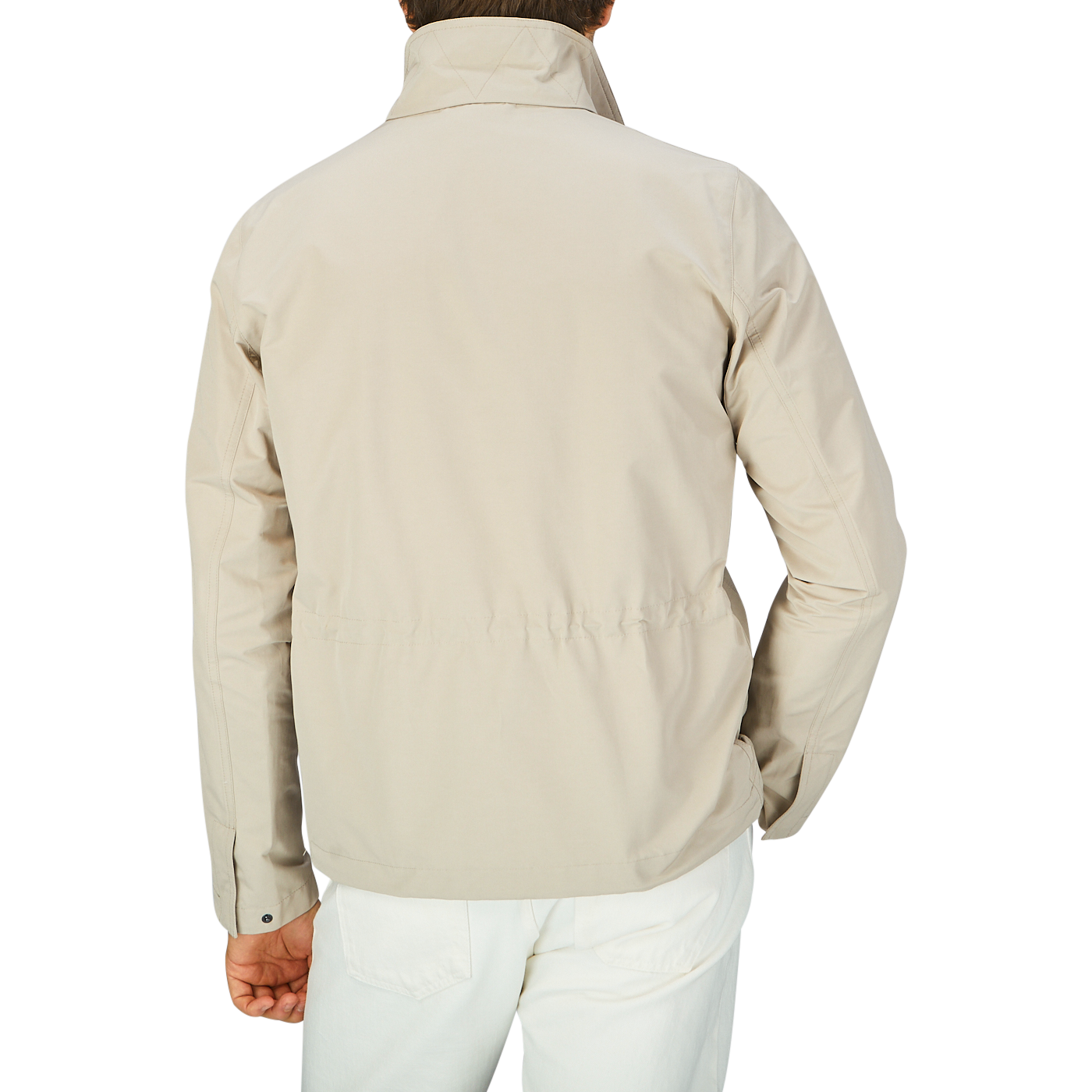 The back view of a man wearing an Aspesi Beige Cotton Canvas Windbreaker Stringa Jacket.