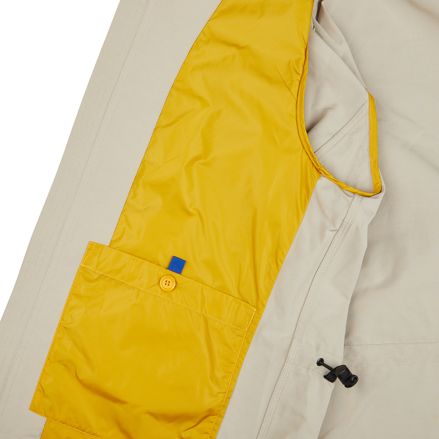 The pocket of a yellow and beige Aspesi Beige Cotton Canvas Windbraker Stringa Jacket.