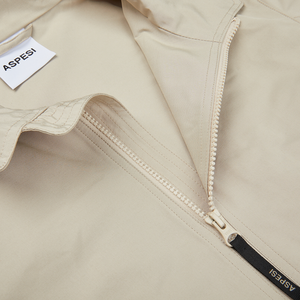 A beige Cotton Canvas Windbreaker Stringa jacket with a zipper on the side by Aspesi.