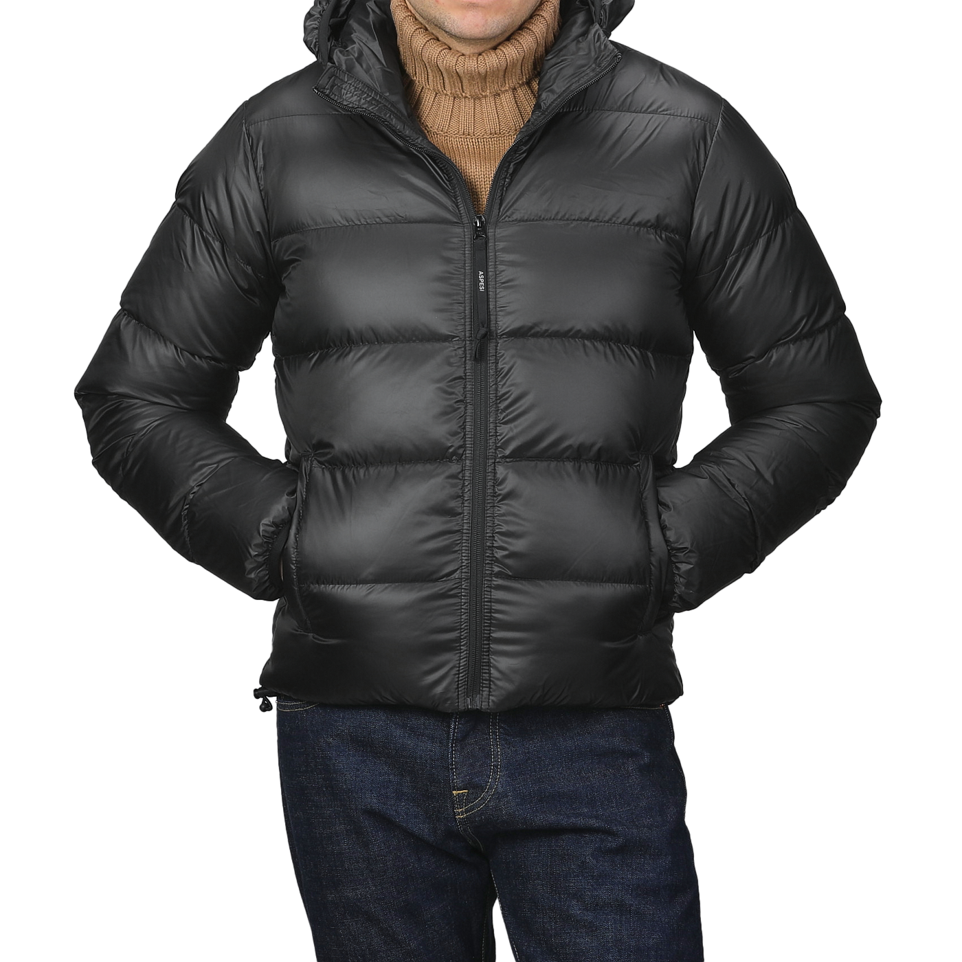 A person wearing an Aspesi Black Nylon Ripstop Down Padded Budd Jacket over a brown turtleneck sweater and blue jeans, with hands in pockets.