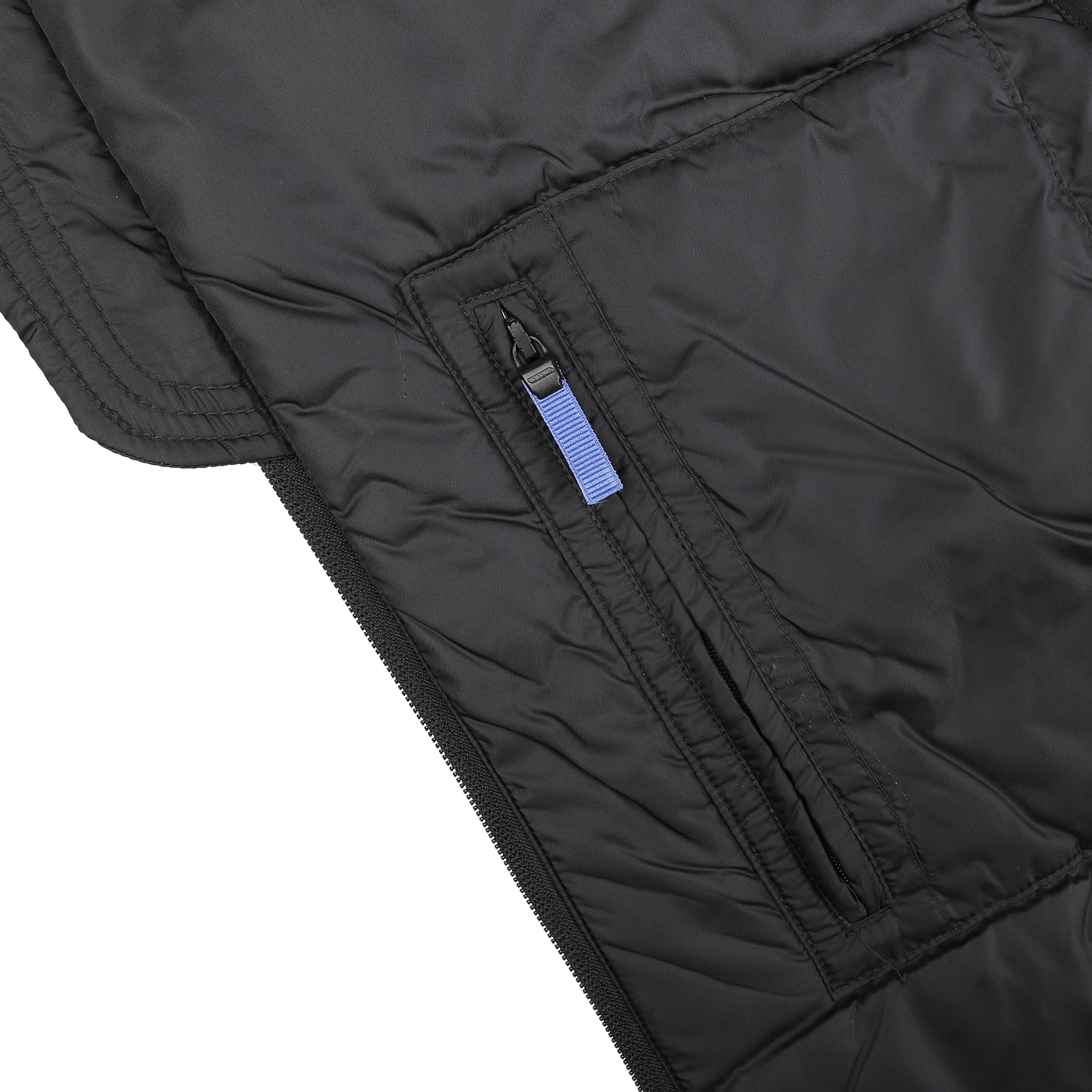 Close-up of the Aspesi Black Nylon Taffetta Thermore Jil Gilet, showcasing its quilted design and featuring a blue zipper pull on a pocket, complemented by Thermore technical down for exceptional warmth.