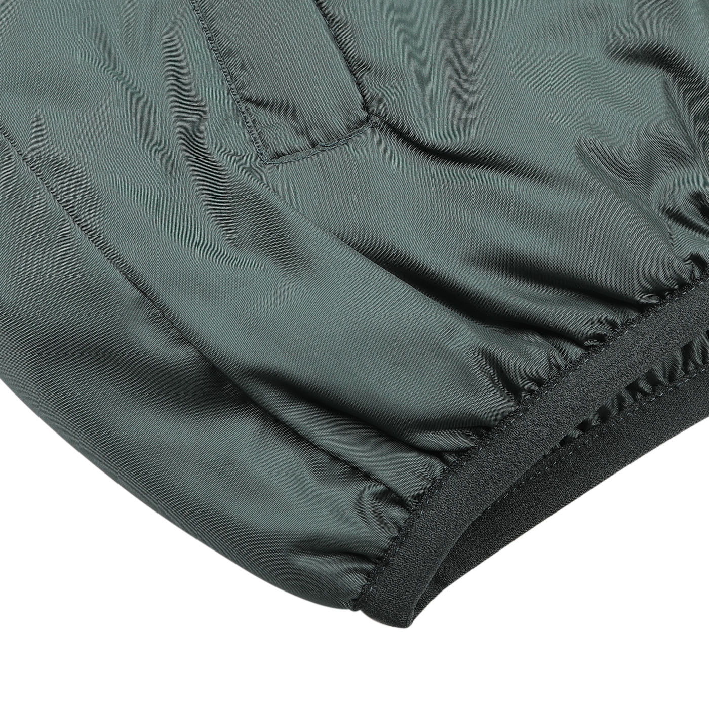 Close-up of the Bottle Green Nylon Taffeta Thermore Jil Gilet by Aspesi, highlighting a sleeve with an elastic cuff that features intricate stitching and texture. The water-repellent finish enhances its practicality and style.