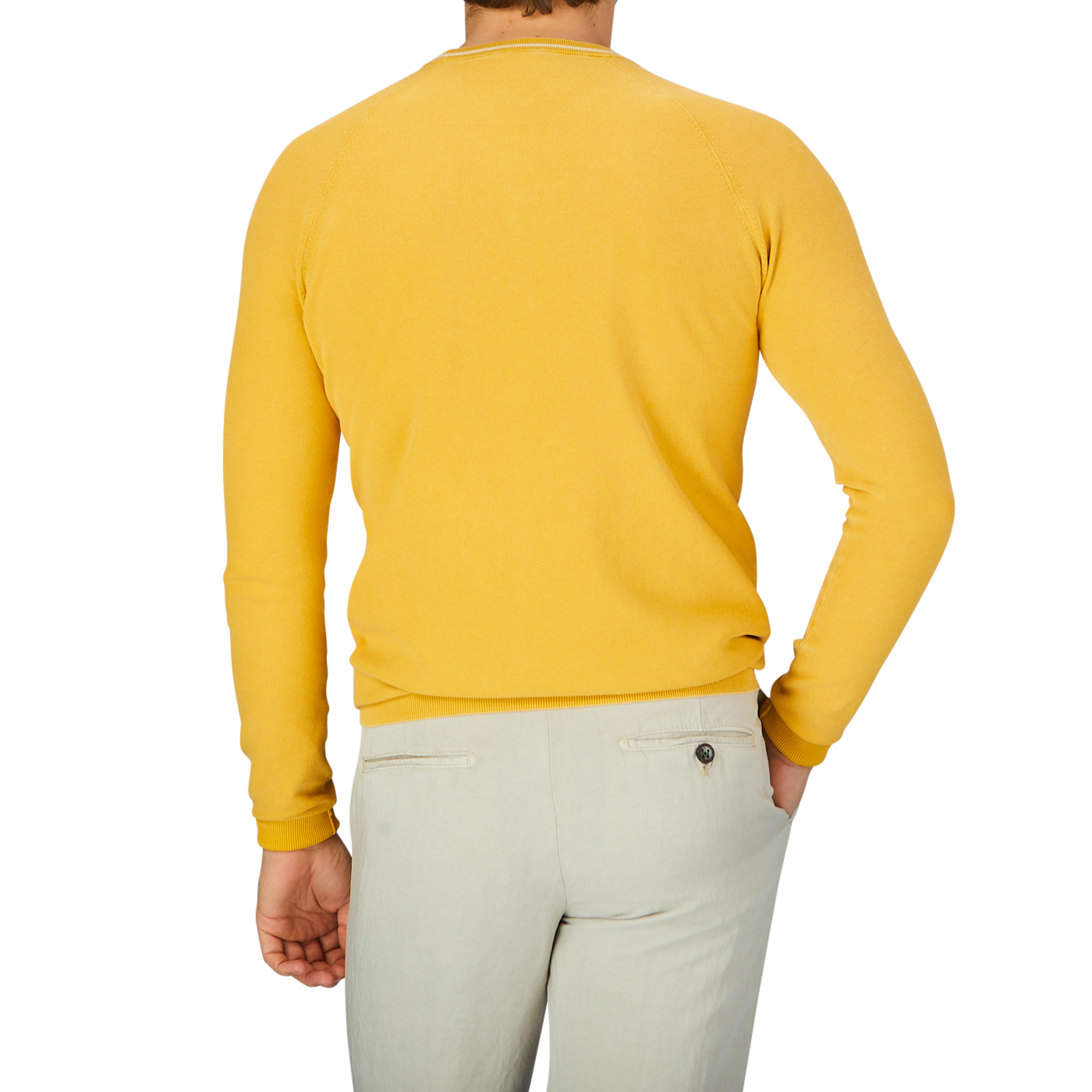 The back view of a man wearing a Aspesi Bright Yellow Cotton Piquet Crew Neck Sweater and khaki pants.