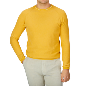 A man wearing a Bright Yellow Cotton Piquet Crew Neck Sweater by Aspesi and khaki pants.
