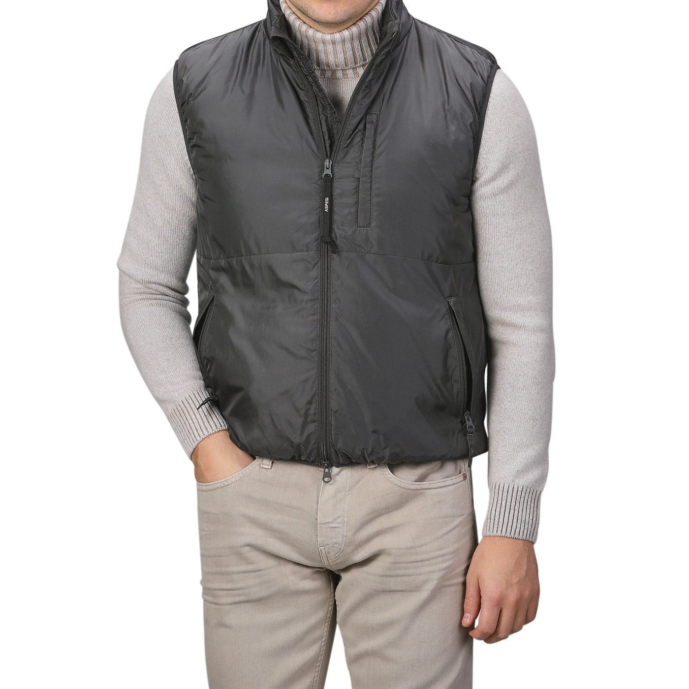 A person wearing the Aspesi Charcoal Grey Nylon Taffetta Thermore Jil Gilet over a gray sweater and light gray pants, with hands in pockets.