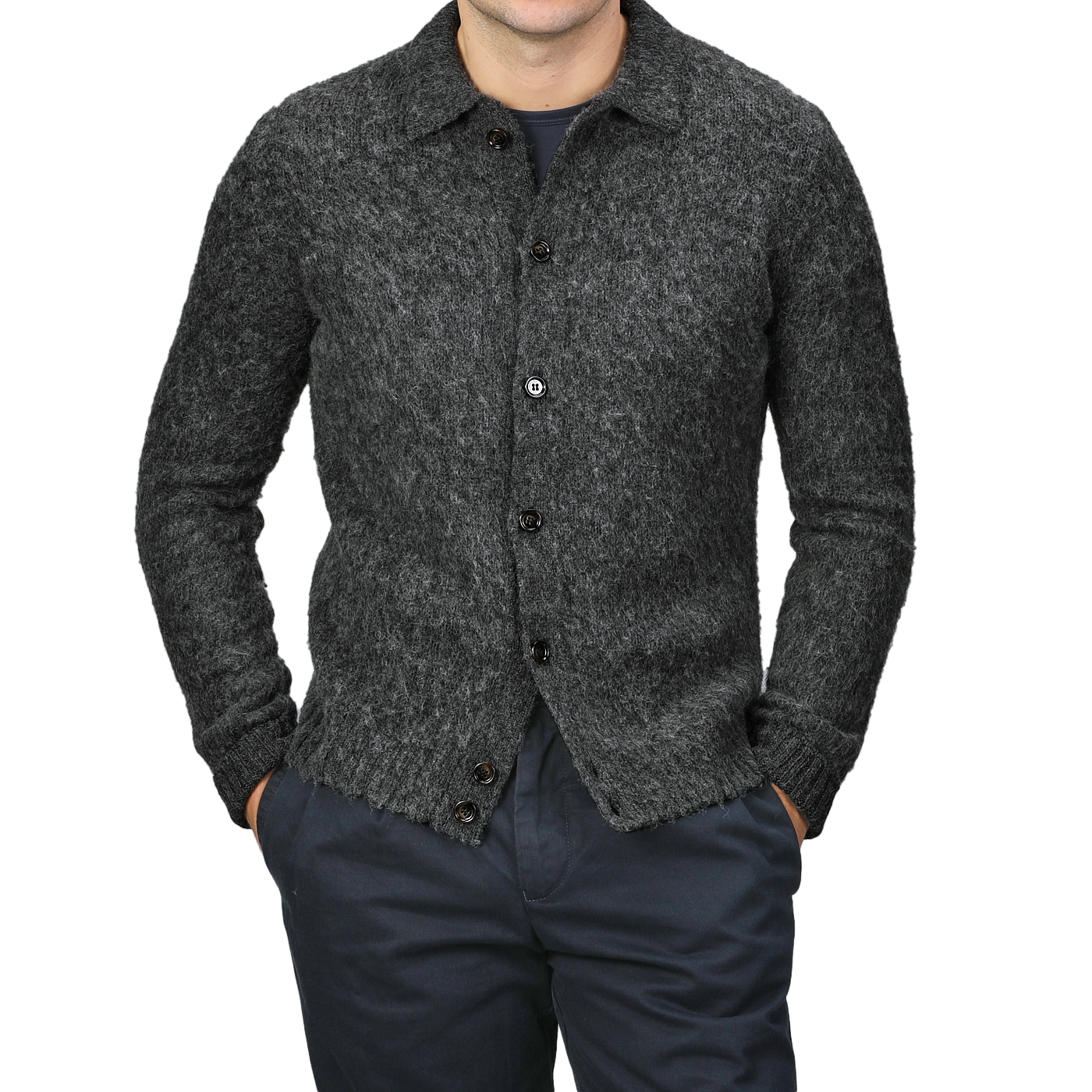 Dressed in Aspesi's Dark Grey Brushed Shetland Wool Cardigan and dark pants, with hands in pockets, a person exemplifies refined elegance.