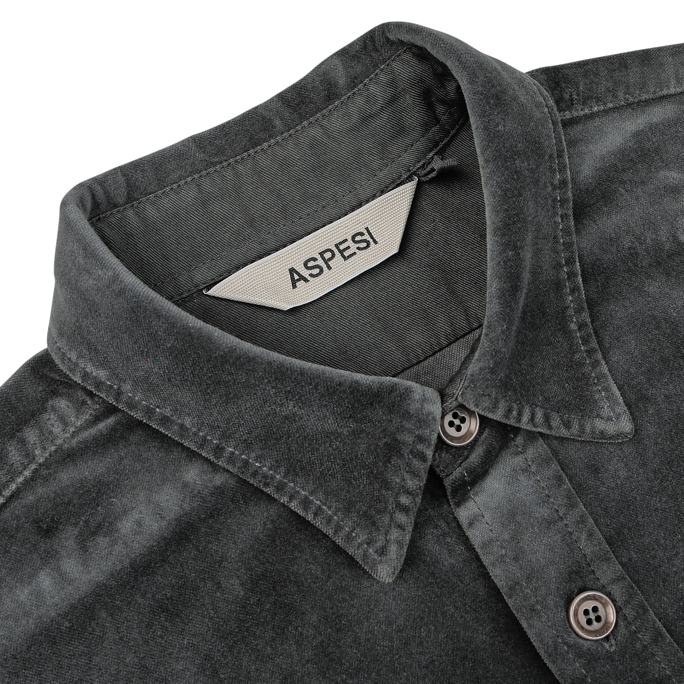 Close-up of the Dark Grey Cotton Velvet Overshirt with a tag inside the collar labeled "Aspesi." This Italian outerwear piece, made from pure cotton velvet, features a button-down collar and visible stitching details.