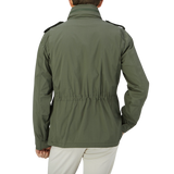 The back view of a man wearing an Aspesi M65 Field Jacket made from waterproof fabric.