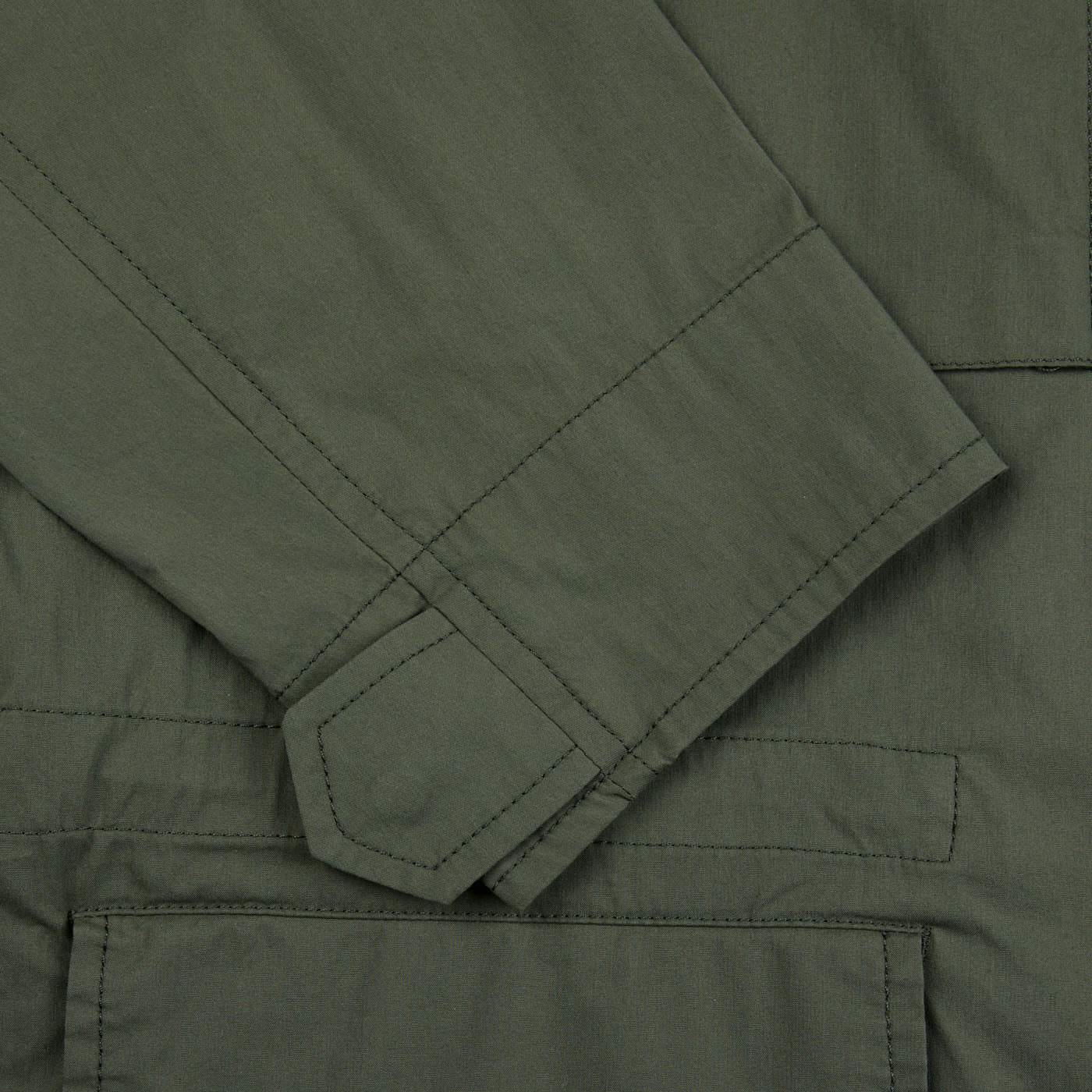 A close up of a military Green Cotton Nylon M65 Field Jacket made by Aspesi with waterproof fabric.