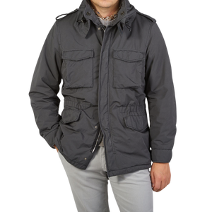 A man is posing in a Aspesi Grey Luxury Nylon Padded Field Jacket.
