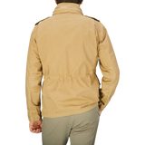 The back view of a man wearing an Aspesi Khaki Beige Cotton Mini Field Jacket, windproof jacket.