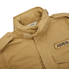 A Aspesi khaki beige cotton mini field jacket with the word Aspesi on it.