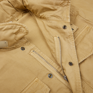 A close up of a Aspesi khaki beige cotton mini field jacket with zippers.