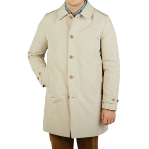 The man is wearing a Light Beige Cotton Thermore Impermeabile Coat by Aspesi.