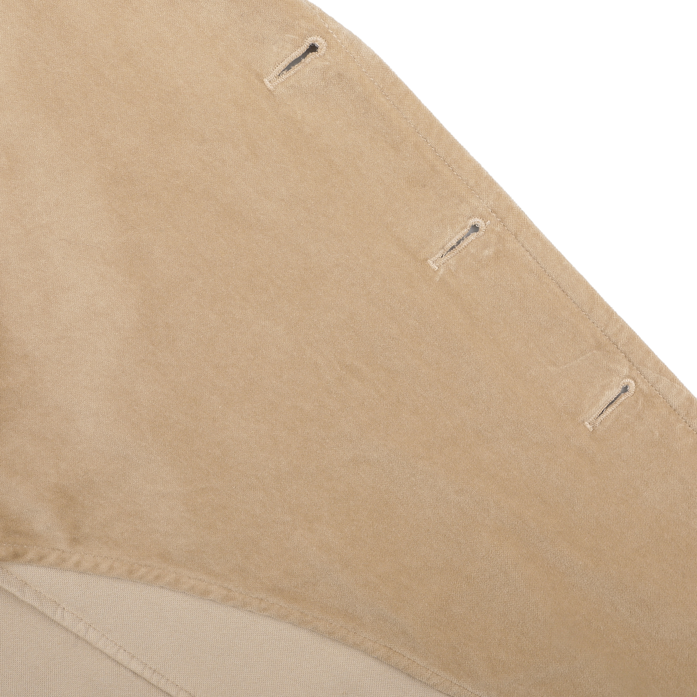 Close-up view of a beige fabric with buttonholes stitched along one edge, reminiscent of the meticulous detailing found on the Aspesi Light Beige Cotton Velvet Isaac Blazer.