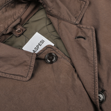 Close-up of the Marrone Brown Micro Nylon Thermore Coat with visible inner lining and "Aspesi" label. This jacket, crafted from technical nylon, features black buttons and stitching details.