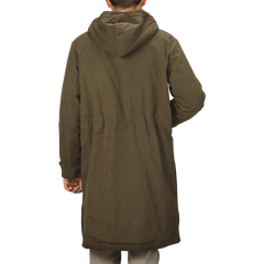 A person is seen from behind, wearing the Aspesi Military Green Cotton Nylon Thermore Rams Parka.