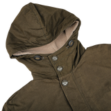 A close-up of the Aspesi Military Green Cotton Nylon Thermore Rams Parka, highlighting its four buttons down the front and revealing its light beige inner lining and Thermore padding for added warmth.