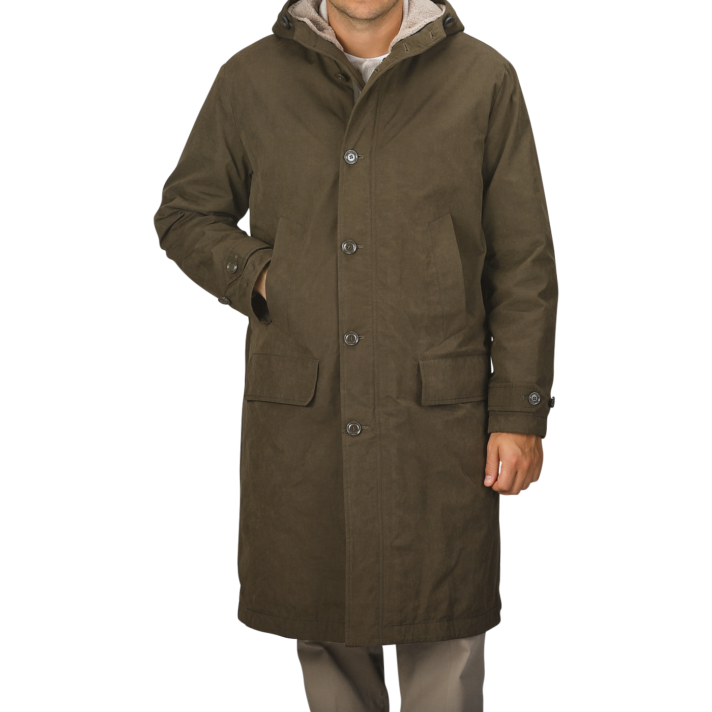 A person wearing an Aspesi Military Green Cotton Nylon Thermore Rams Parka with a hood and four buttons stands against a plain background.