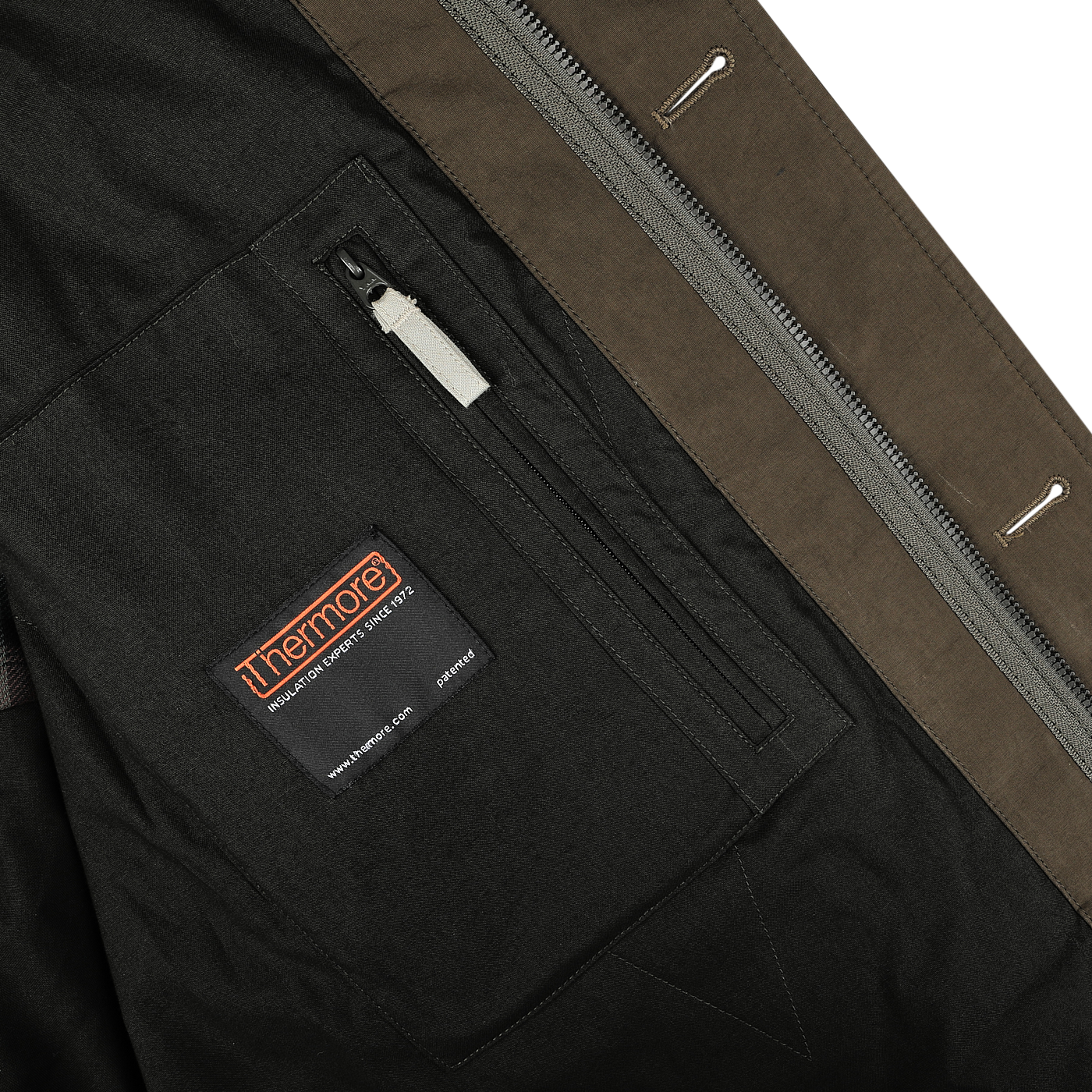 Close-up of the Aspesi Military Green Cotton Nylon Thermore Rams Parka's inner pocket, featuring a zipper and a stitched label reading "Innermost" along with care instructions. The jacket boasts a two-tone design with brown and dark gray fabrics, enhanced by Thermore padding for added warmth.