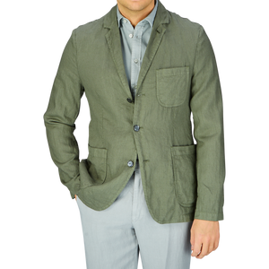 Man wearing an Aspesi Moss Green Washed Linen Samuraki Jacket and light-colored trousers.