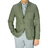Man wearing an Aspesi Moss Green Washed Linen Samuraki Jacket and light-colored trousers.