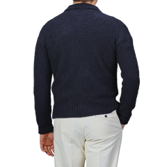 A man is shown from the back against a plain background, wearing an Aspesi Navy Blue Brushed Shetland Wool Cardigan and light-colored pants.