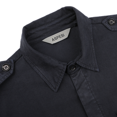 A close-up of the Navy Blue Cotton Twill Field Shirt by Aspesi, featuring shoulder tabs and a visible label inside the collar, crafted from a soft cotton-lyocell blend in a regular fit.