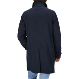 The back view of a man wearing a Aspesi Navy Blue Micro Nylon Limone Coat.