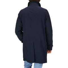 The back view of a man wearing a Aspesi Navy Blue Micro Nylon Limone Coat.