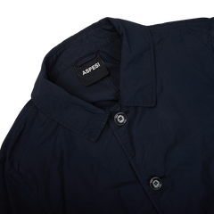 The back of an Aspesi Navy Blue Micro Nylon Limone Coat with a button on the front, designed as a weather-resistant technical coat.