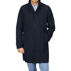 A man wearing a Navy Blue Micro Nylon Limone trench coat by Aspesi.