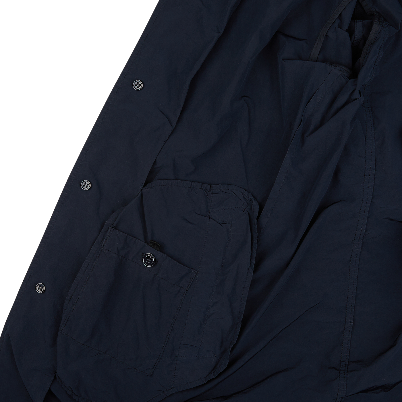 A close up of an Aspesi Navy Blue Micro Nylon Limone Coat on a white surface.